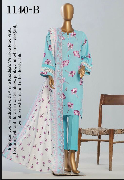 Turquoise floral dress with matching pants and dupatta on a mannequin against a white background.